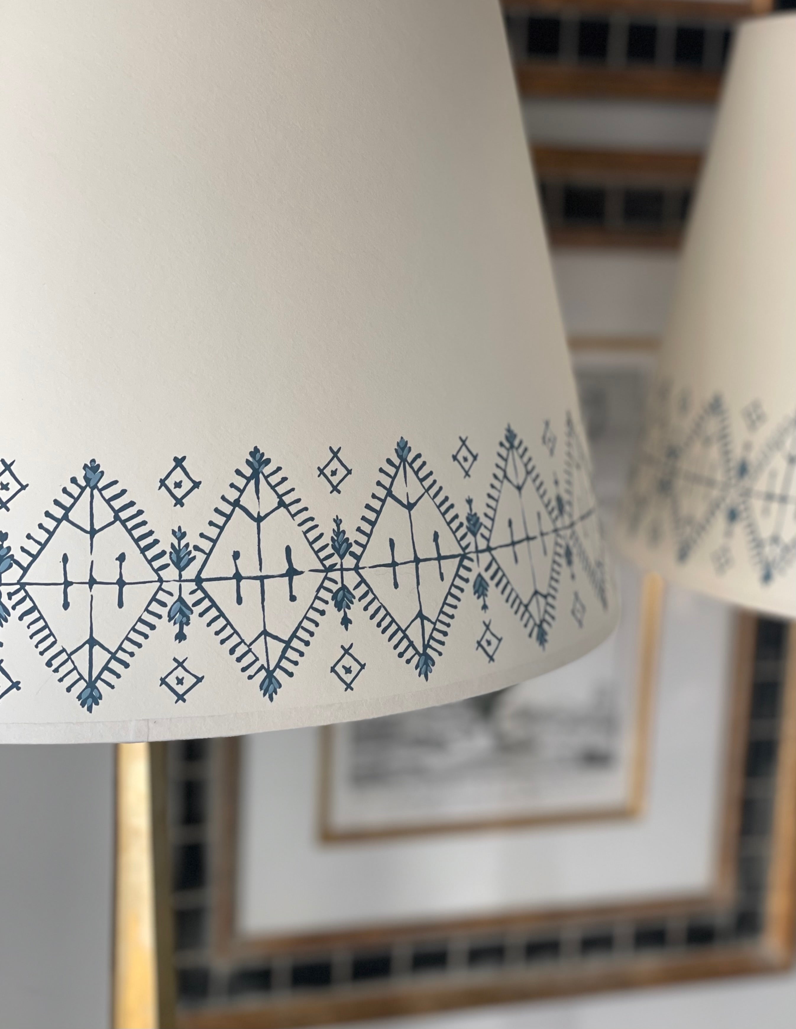 Cream card lampshades handpainted with a Moroccan border in blue