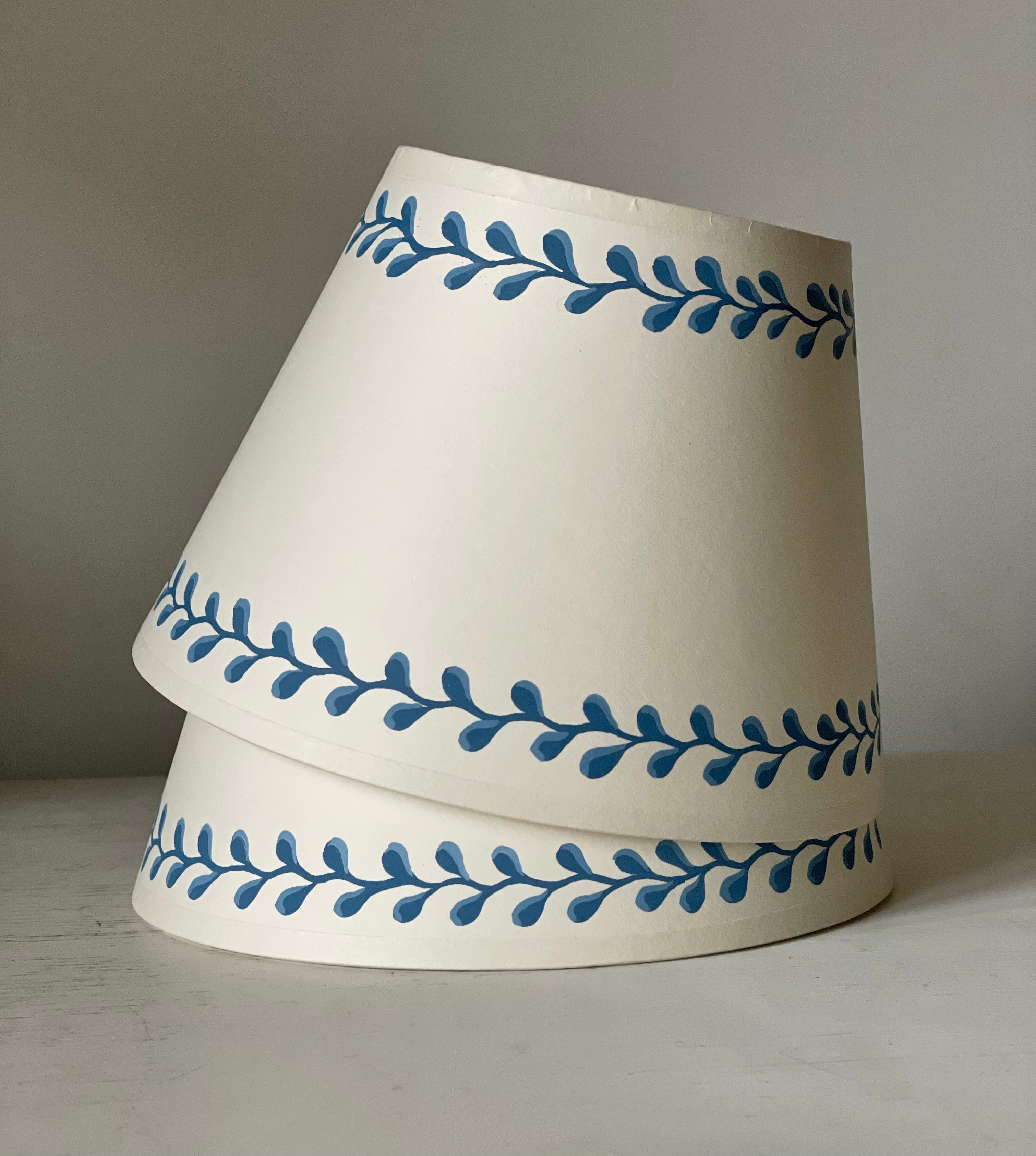 pale cream card lampshades with a blue squiggle handpainted border