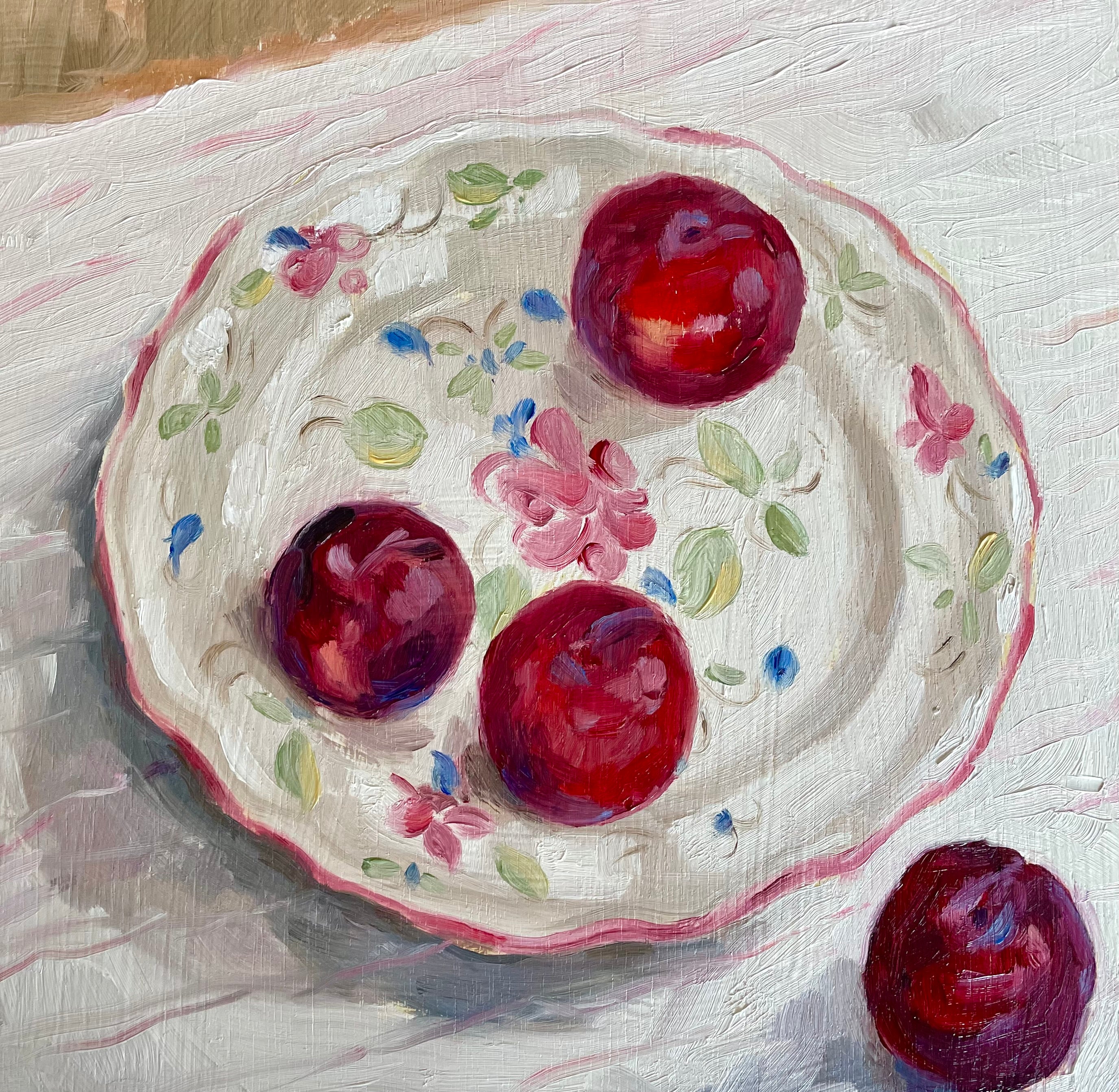 oil painting of plums on a floral plate